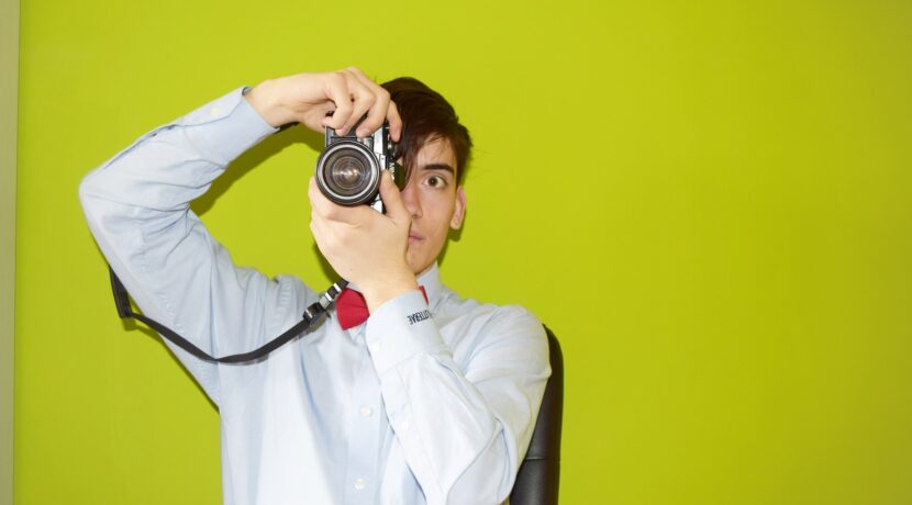 man holding DSLR camera
