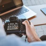 person holding black DSLR camera