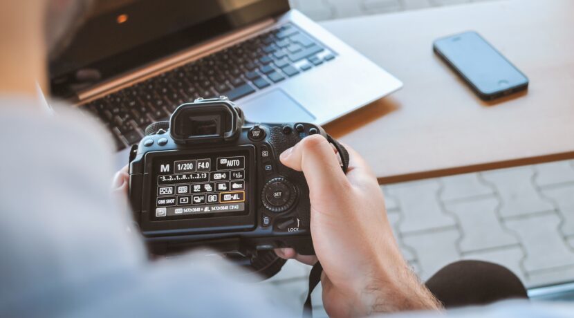 person holding black DSLR camera