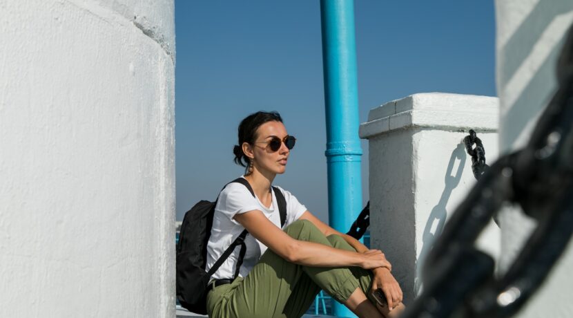 a woman sitting on the ground with a backpack