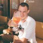 a man holding a glass of wine