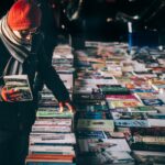 man picking up book ob book sale