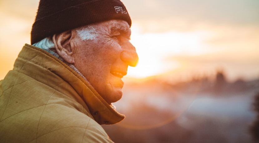 man wearing brown jacket and knit cap