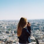 woman taking photo the city