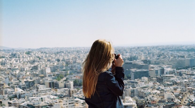 woman taking photo the city