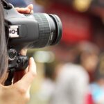 shallow focus photography black Canon DSLR camera