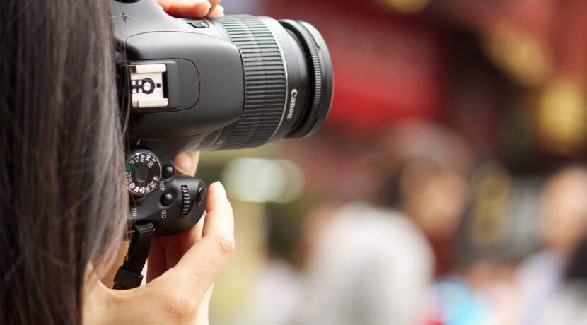 shallow focus photography black Canon DSLR camera