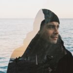 woman in black hijab near body of water during daytime