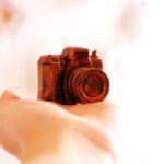 red camera scale model on human hand