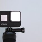black and pink camera on tripod