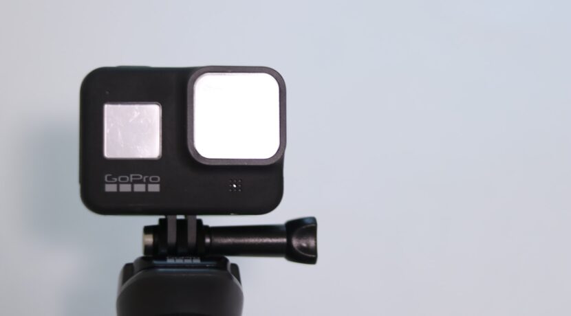 black and pink camera on tripod