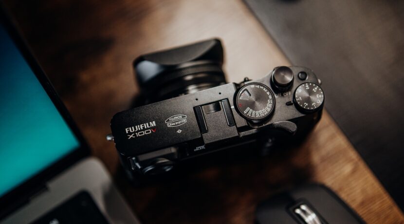 a camera sitting on a desk next to a laptop