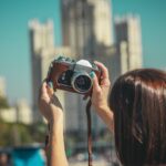 woman holding black and silver camera