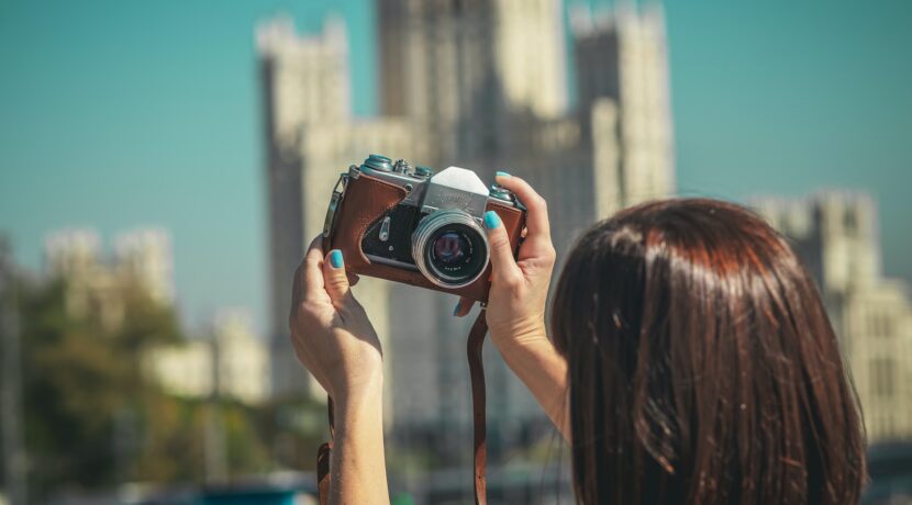 woman holding black and silver camera