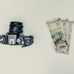 black dslr camera beside 20 banknote