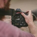 person holding black camera taking photo of animal
