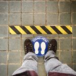 person in gray pants and blue sneakers