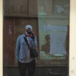 a man taking a picture of himself in a mirror