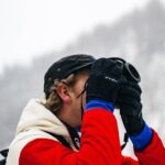person holding camera on snow field