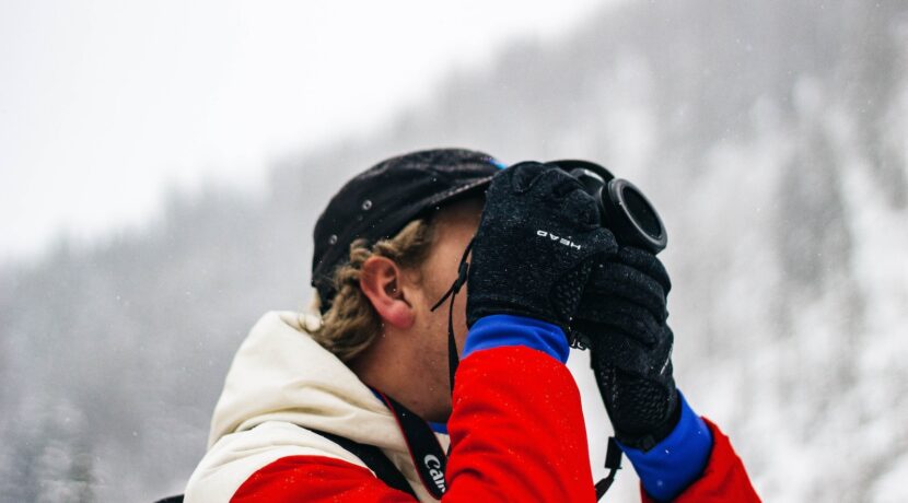 person holding camera on snow field