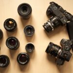 a group of cameras sitting on top of a wooden table
