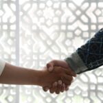 a close up of two people shaking hands