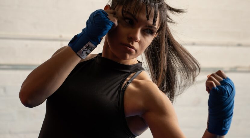 a woman in a black shirt and blue gloves