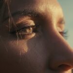 a close up of a woman's face with a building in the background