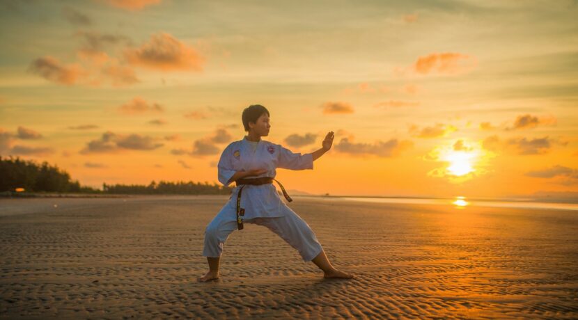boy doing karate routines during golden hour