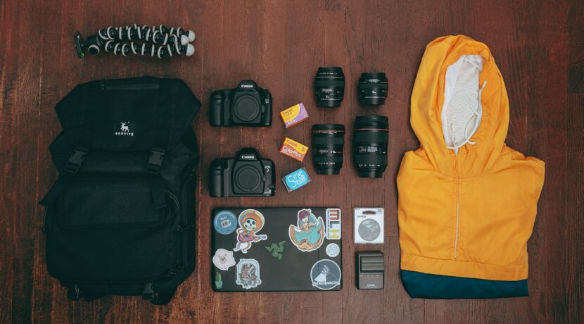 black dslr camera lens and yellow jacket on brown wooden table
