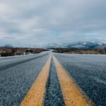 landscape photography of asphalt road under cloudy sky during daytime