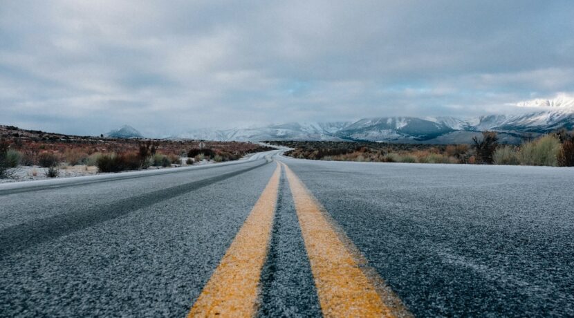 landscape photography of asphalt road under cloudy sky during daytime