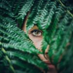 person hiding on tree leaves