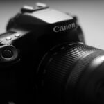 black nikon dslr camera on white table