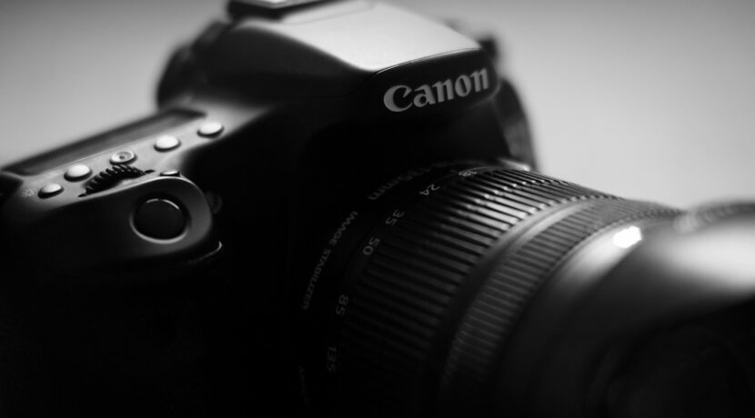 black nikon dslr camera on white table
