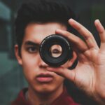 selective focus photography of man wearing red top