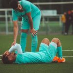 a soccer player is laying on the ground