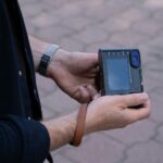 a man holding a cell phone in his hand