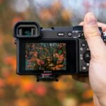 person holding black dslr camera