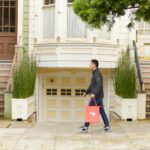 man walking with DoorDash bag