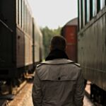 man standing between tanks