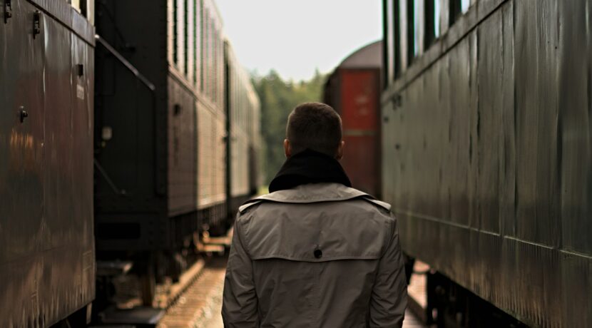 man standing between tanks