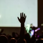silhouette photography of human hand raising