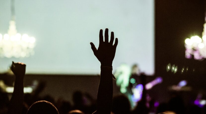 silhouette photography of human hand raising
