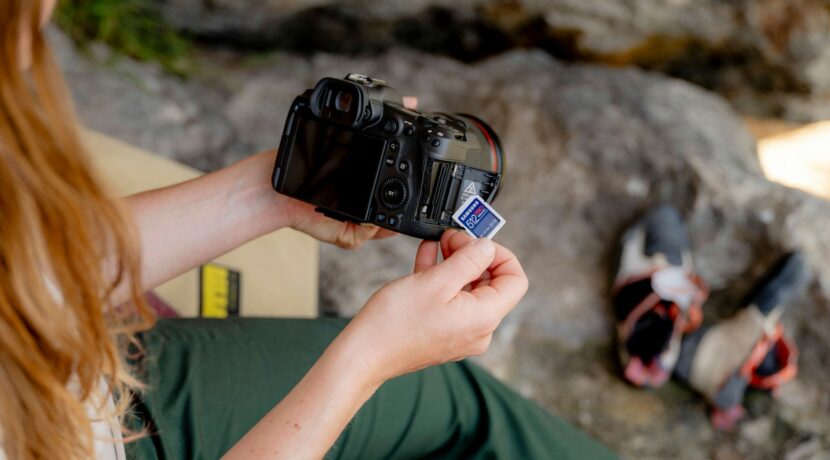 A woman sitting on a chair holding a camera
