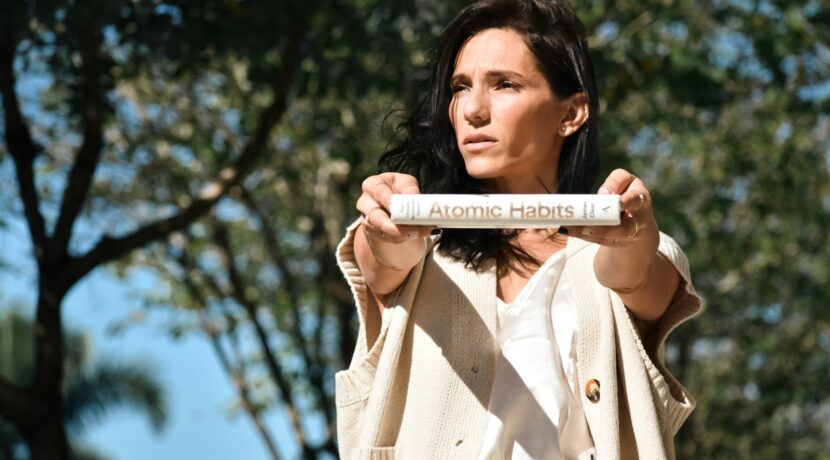 a woman holding up a tube with a label on it