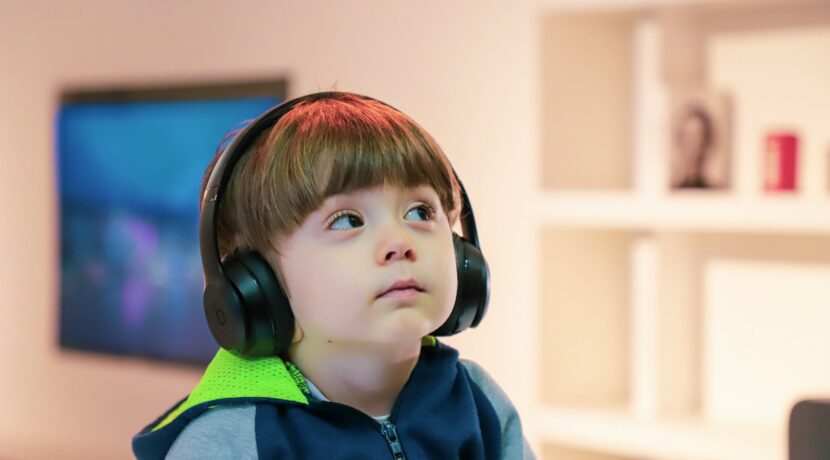 boy near white wooden shelf
